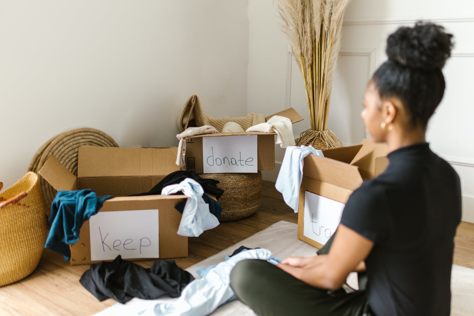 a woman sitting in front of cardboard boxes