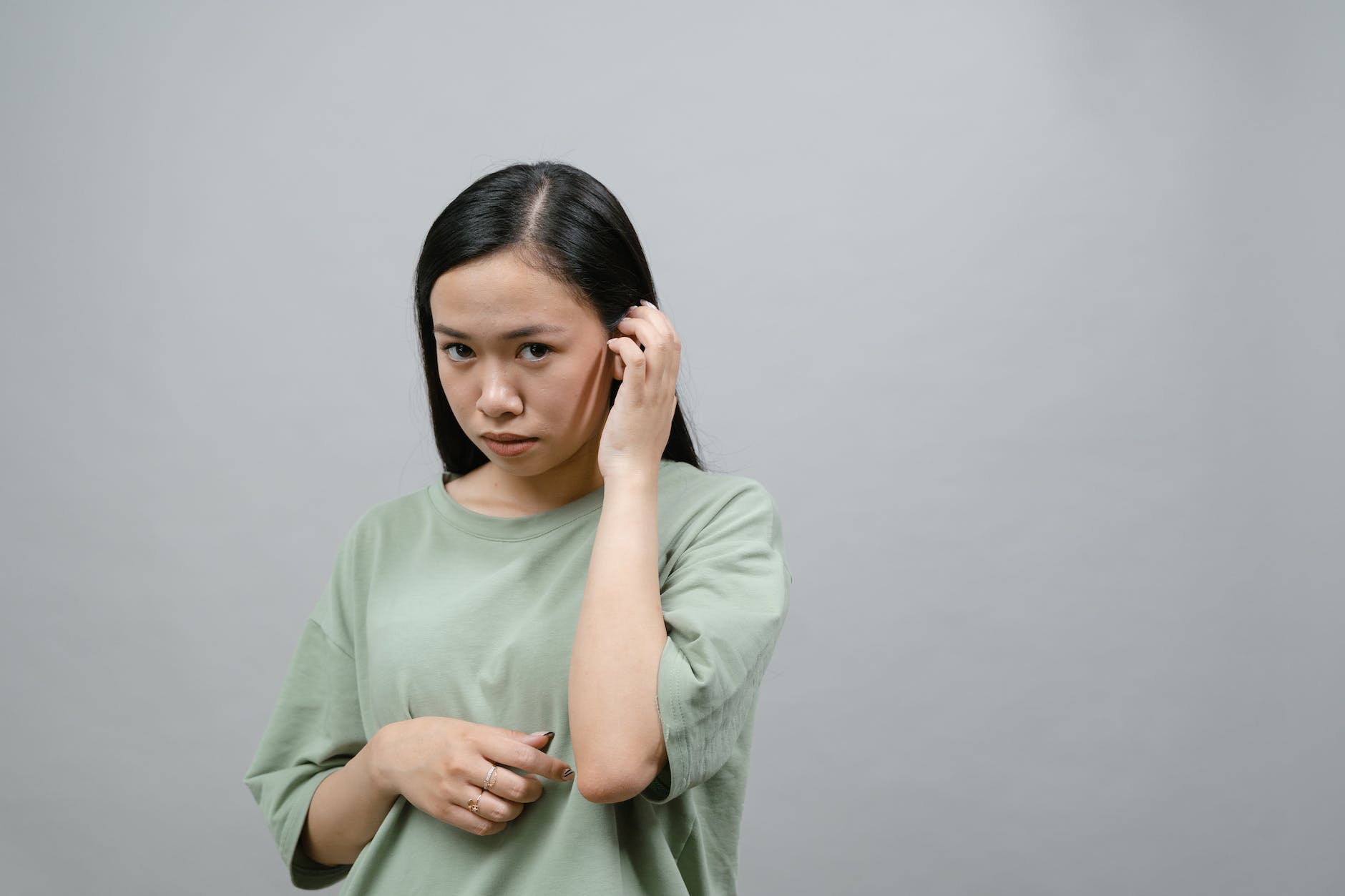 a shy woman in green shirt