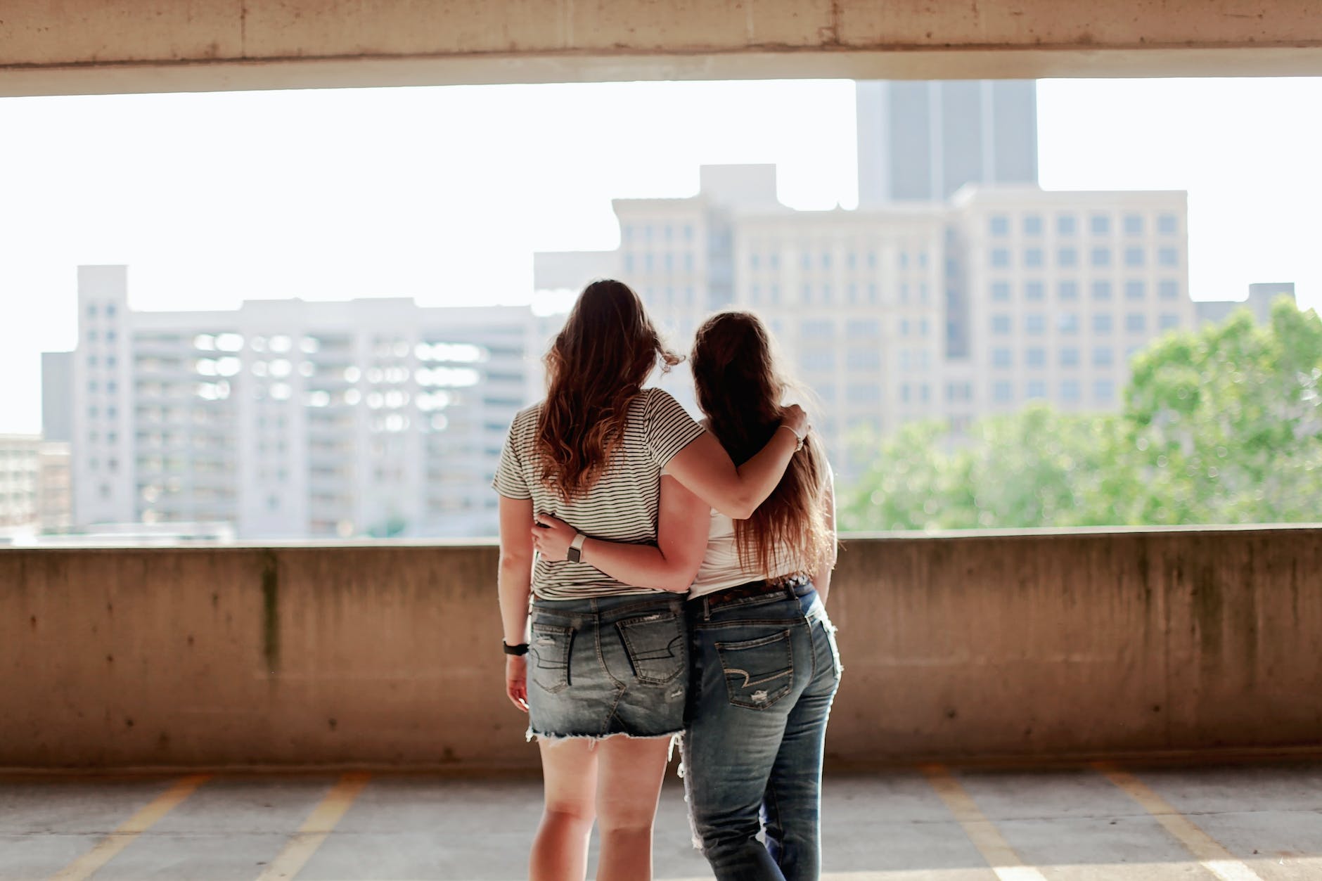 two women standing inside parking lot