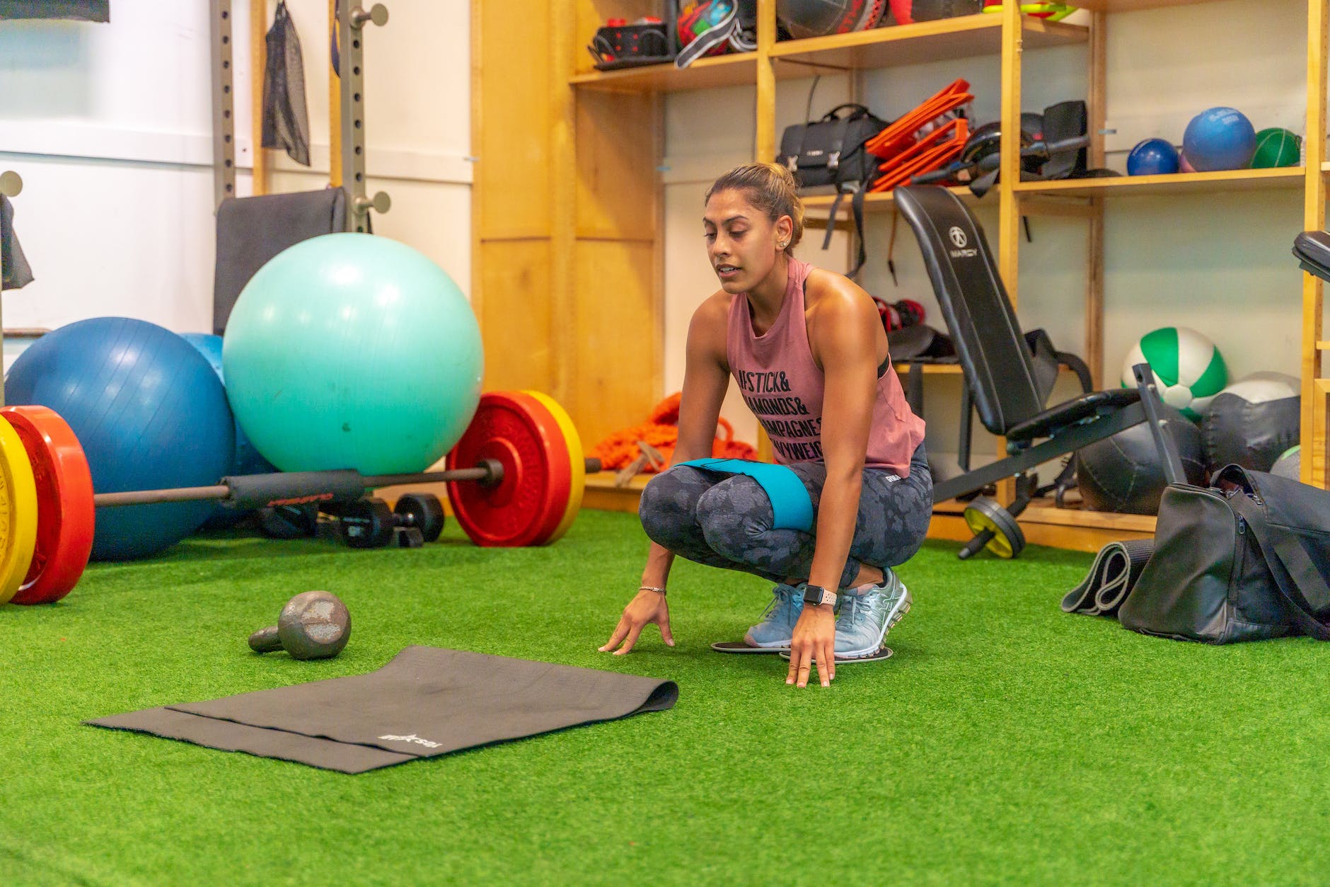 photo of a woman in a pink tank top working out