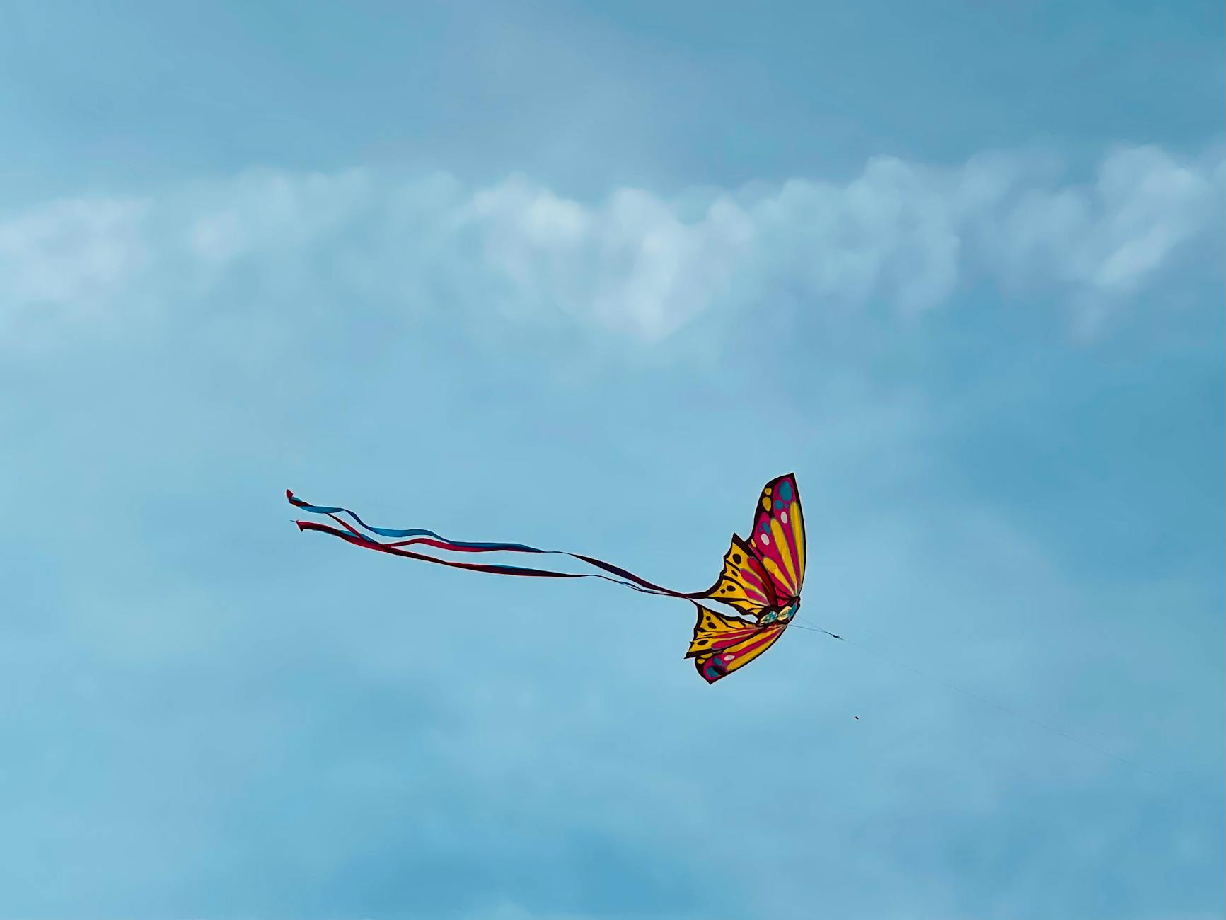 flying kite against the blue sky