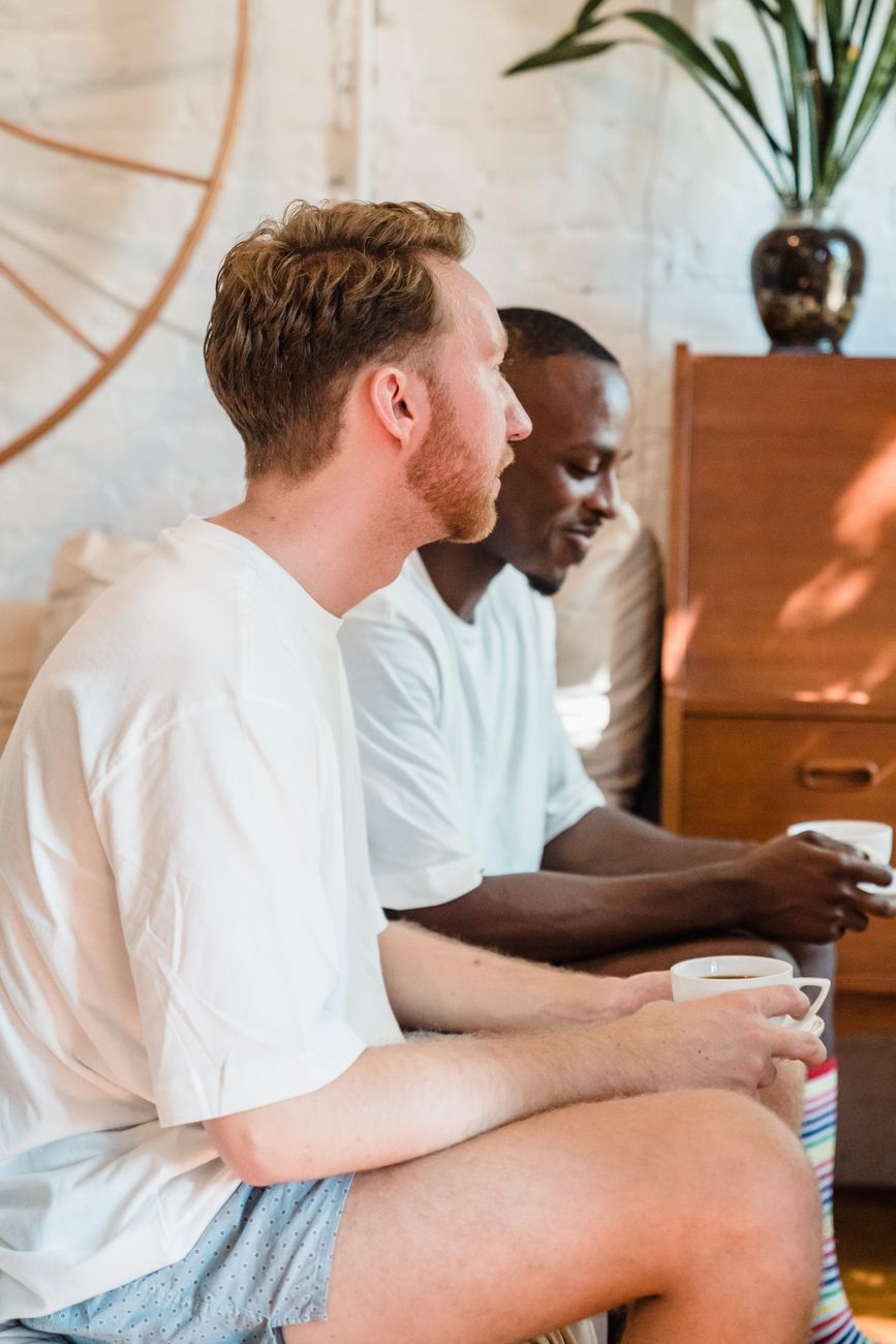 men sitting at home drinking coffee together