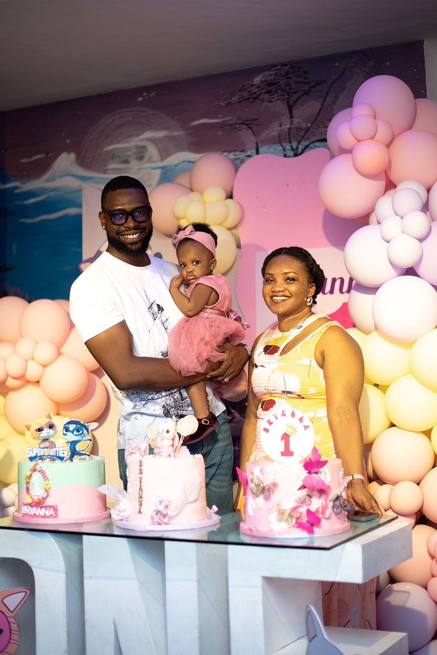 smiling parents with their daughter
