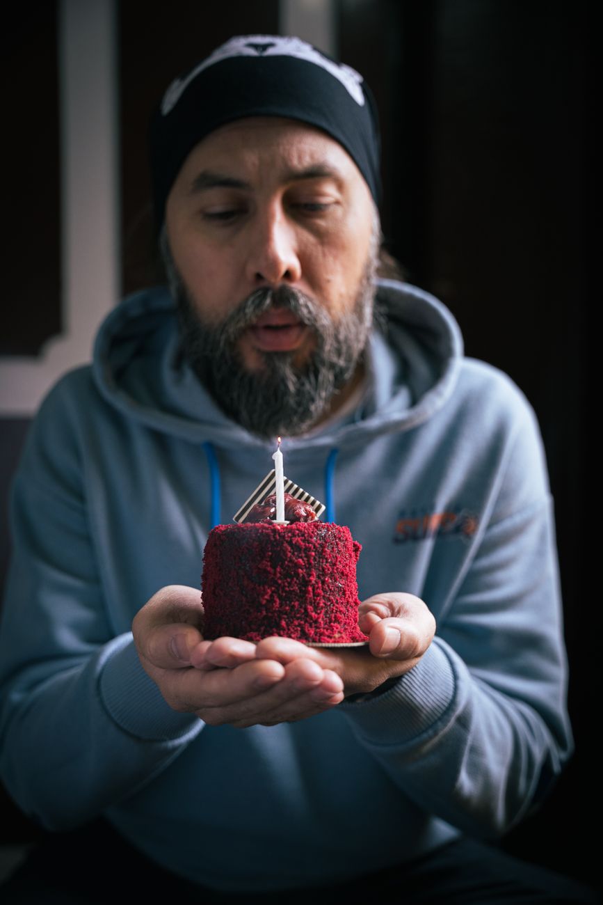 man celebrating birthday with a small cake