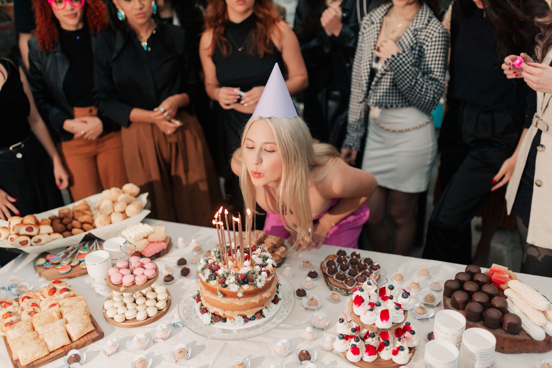 joyful birthday celebration with friends and cake photo by alexander mass