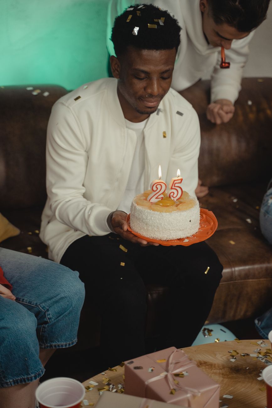 a man holding a birthday cake