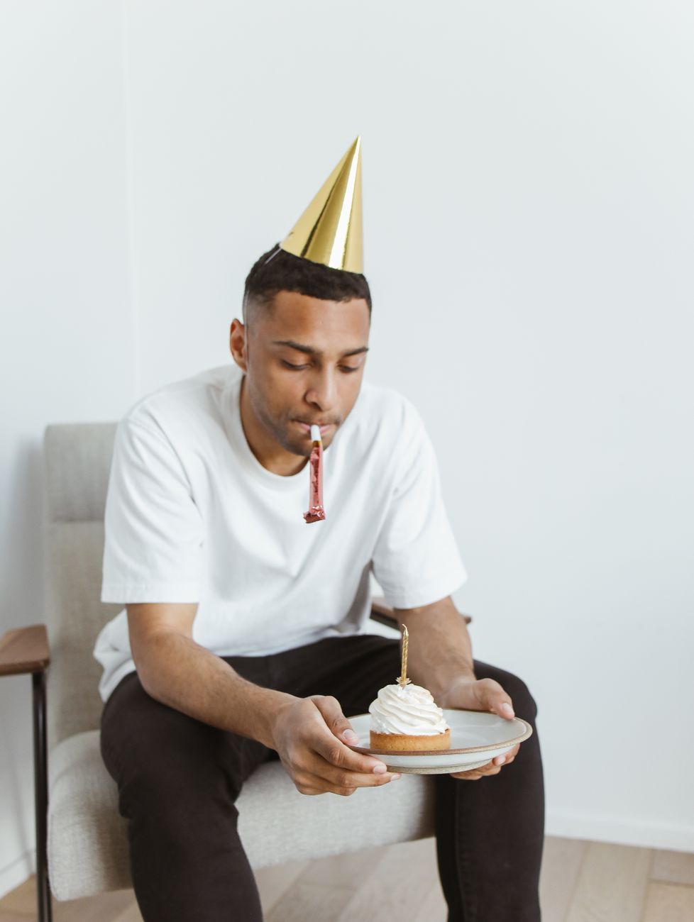 lonely man holding birthday cake on plate