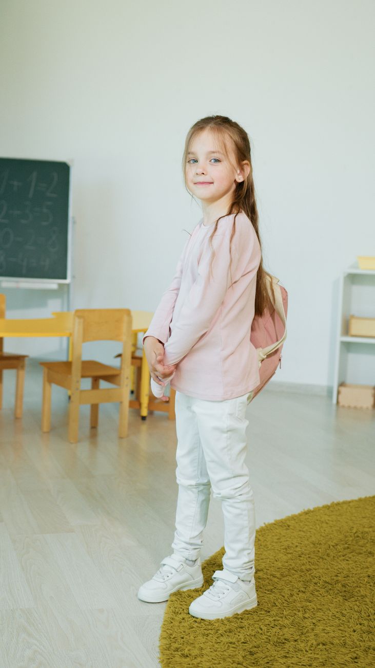 a young girl carrying her backpack
